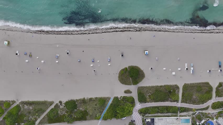 Aerial view of Miami Beach coastline with turquoise Atlantic water, sandy shore and urban waterfront, Florida USA. g.