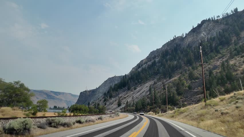 Landscape of mountain and road. Travel destination. Landscape route. Scenic nature autoroute. Rainy weather road among mountain. Road though mountain landscape