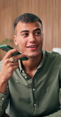 Phone call, talking and man in home, loudspeaker and digital app for communication. Apartment, mobile user and person in living room, smartphone and chatting with recording, listening and voice note