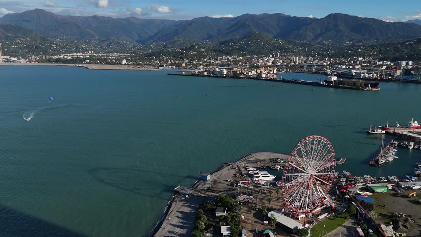 Horizontal drone shot of the Batumi port with mountains in the background, Georgia.