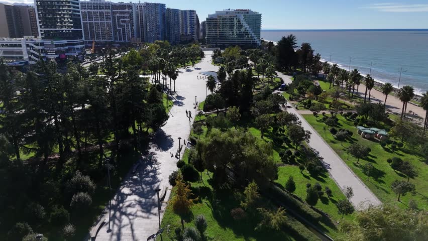 Wide aerial shot of the green recreational zone and walking paths in Batumi, Georgia.