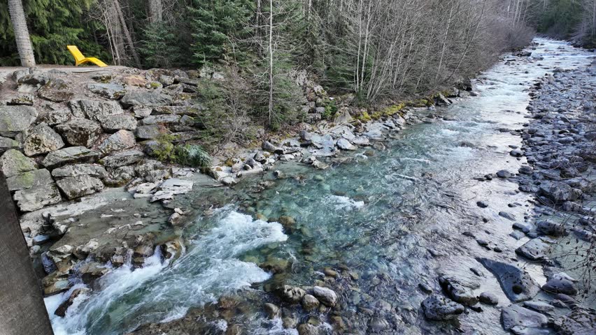 Fitzsimmons Creek is a fast moving stream made up of glacial water in British Columbia, Canada. Scenic viewpoint from an enclosed bridge in Whistler Village.