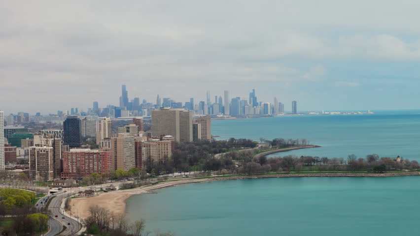 Chicago skyline and Lake Michigan coastline on a cloudy day. Overcast cityscape with downtown skyscrapers and waterfront.