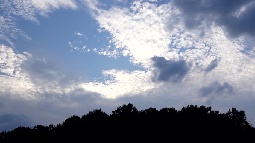 Scenic View of Mountains Under Clear Blue Sky with Fluffy Clouds