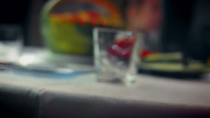 Two young girls are seated at a birthday table with food on plates