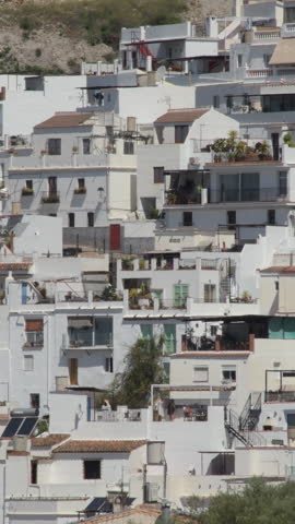 Andalusian village of Competa in Spain, with with white houses. 4K Vertical