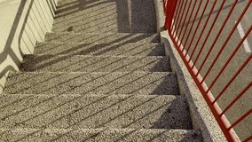 A staircase with steps made of Jerusalem stone and red railings in sunny weather. - Powered by Shutterstock - Get 15% off with code: PIKWIZARD15