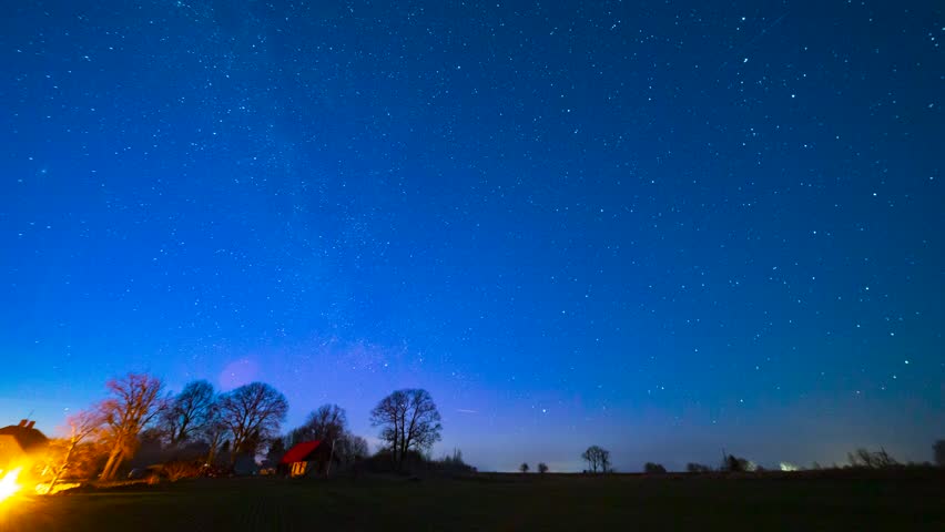 A small Aurora Borealis and starry sky over rural landscape with house in front