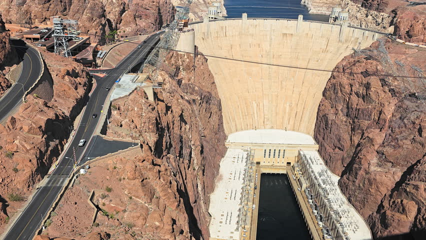 Hoover Dam Nevada Arizona border aerial view of massive concrete arch structure and Colorado River canyon landscape in Mojave Desert