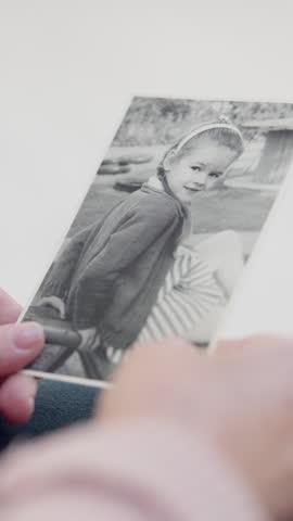 Hands, picture and memory for childhood in home for nostalgia, relax and senior person in retirement. Elderly woman, remember and vintage photograph with monochrome, girl and daydream at apartment
