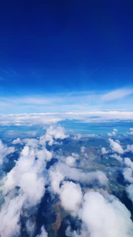 VARADERO, CUBA - DECEMBER 20, 2023: View from the porthole on the Atlantic coast of Cuba. View of the turquoise ocean water and islands with snow-white sand from the plane. White clouds over the water