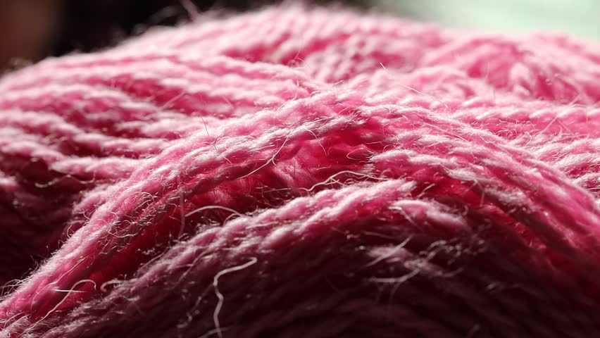 A close-up shot of a bright pink yarn ball, ideal for crafting and DIY projects.