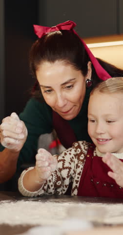 Happy child, mom or clapping hands with baking flour in kitchen for fun bonding together in home. Mother, daughter and playing with junior baker or smile for christmas cookies or dessert in house