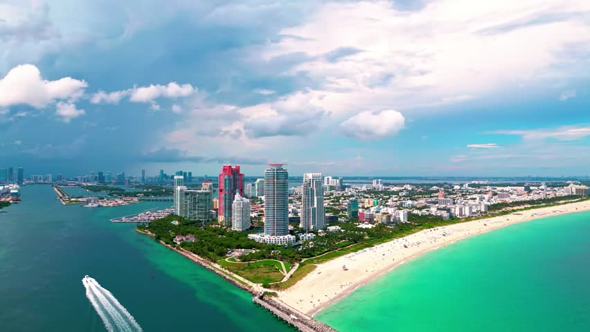 A breathtaking birds-eye aerial drone shot capturing the vibrant turquoise and azure waters of Biscayne Bay, Florida. The footage reveals the intricate patterns of submerged sandbars and shallow reefs, showcasing the natural beauty of the South Florida coastal ecosystem. The clear, calm water creates a serene tropical aesthetic, making it ideal for travel documentaries, luxury lifestyle content, environmental features, and vacation-themed projects. This high-angle perspective highlights the pristine aquatic environment of the Miami coast.