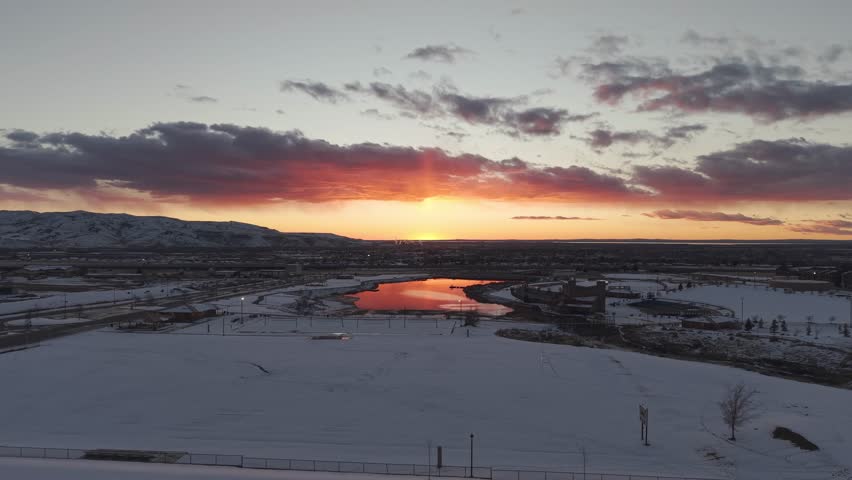 Sunset reflecting off pond in Pocatello, Idaho with drone.