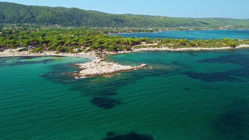 Aerial View of the unique white rock formations and shallow turquoise water at Karydi beach in Vourvourou, Sithonia, Chalkidiki, Greece