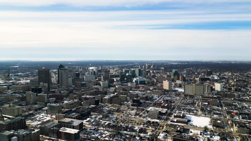 Wide timelapse drone shot of downtown Winnipeg in winter during daytime