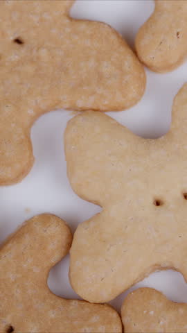 Closeup of baked bear treats. Warmly lit scene featuring overlapping bearshaped cookies. Artisan bakery style with cozy ambiance showcasing bearshaped baked delicacies