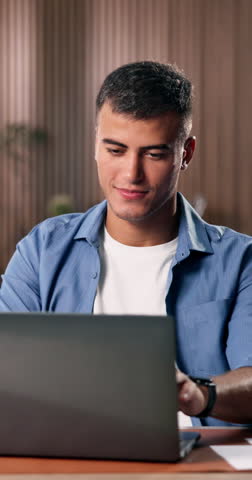 Business man, laptop and happy in creative office for online research, typing and update content or article. Male journalist, smile and writing story for magazine blog, report or planning on web