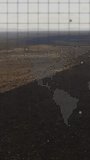 Vertical video: HUD activating, dotted Americas anchoring as camera tilting showing road for map. Aerial, desert, arid, horizon, grid, overlay, vertical video - Powered by Shutterstock - Get 15% off with code: PIKWIZARD15