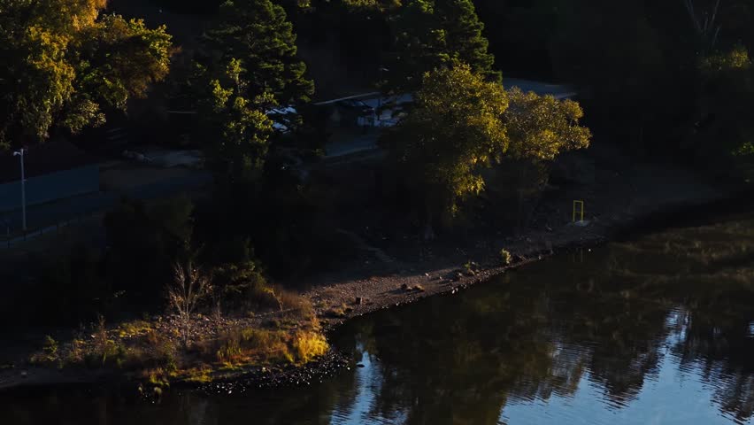 Autumn Trees Reflected Over River Near Carpenter Dam Road Bridge In Hot Springs, Arkansas, USA. Tracking Shot