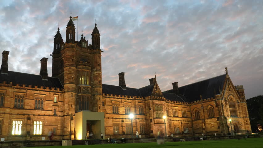 Time lapse of University of Sydney at sunset with dramatic sky over historic campus architecture