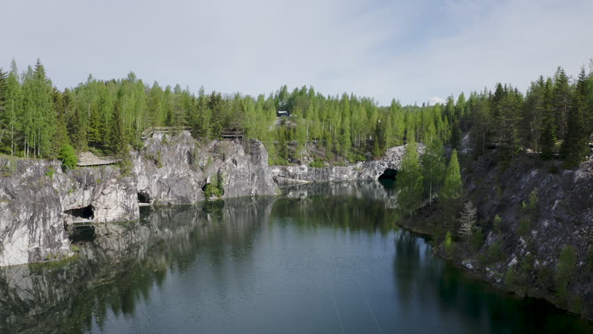 Aerial footage of Bolshoy Mramorny Canyon Lake in Mining park Ruskeala. Karelia, Russia.