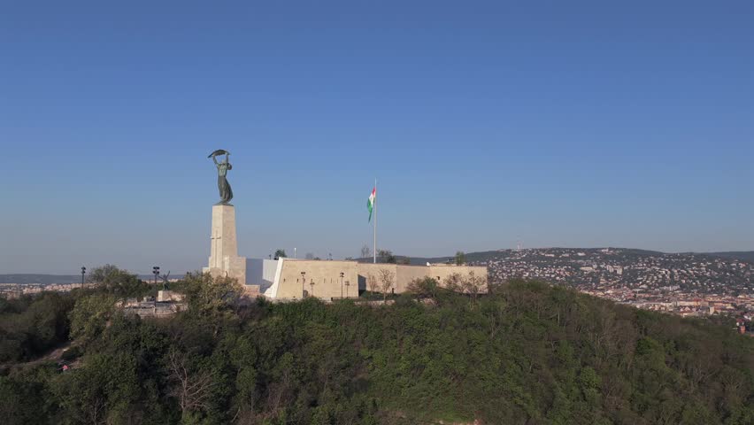Renovated Liberty Statue, Szabadság Szobor, Citadella visitor center and Hungarian flag on Gellért Hill in Budapest, Hungary.