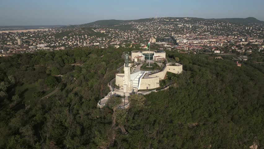 Renovated Liberty Statue, Szabadság Szobor, Citadella visitor center and Hungarian flag on Gellért Hill in Budapest, Hungary.