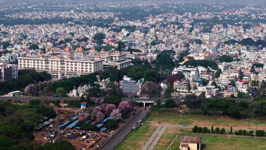JSS Hospital with Residential buildings, trees and MG road at Mysore, karnataka, india, day time, push in shot, drone shot, 4k.