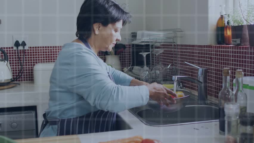 Senior woman rinsing veg at sink running faucet activating user icons into growing network for tech. Vegetables, washing, kitchen, bowl, water, preparation, connectivity
