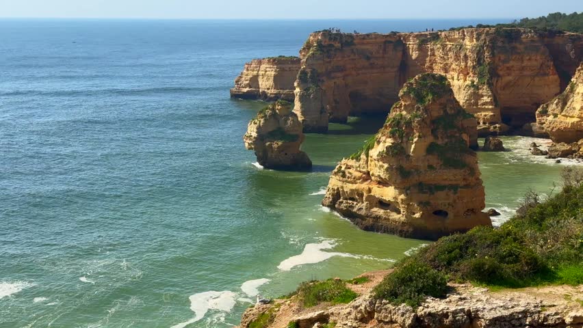 Slide view over empty Pinhao Beach in Lagos Coastline, Algarve, Portugal Aerial wide slide overview shot
