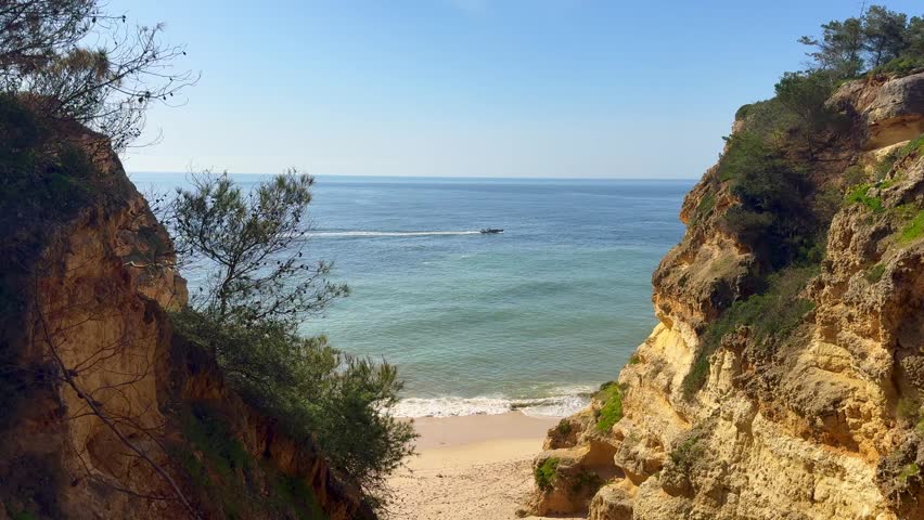 Slide view over empty Pinhao Beach in Lagos Coastline, Algarve, Portugal Aerial wide slide overview shot