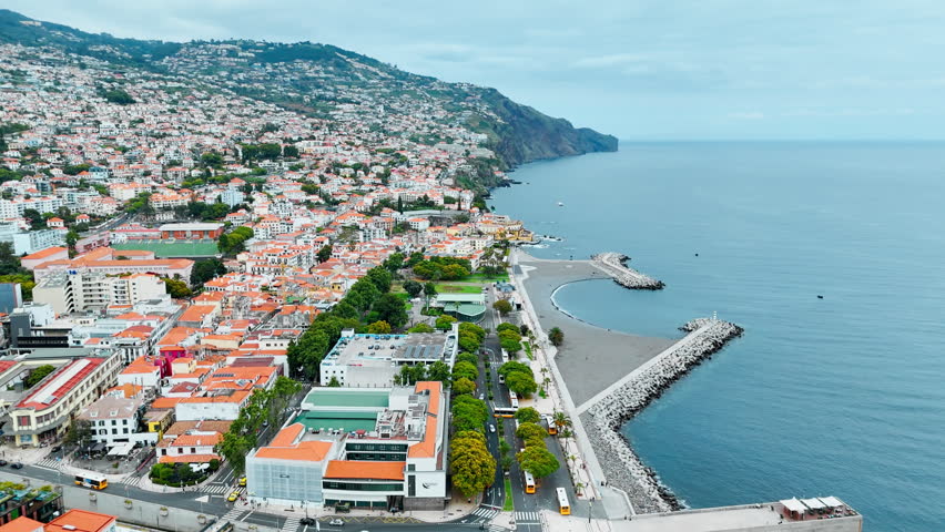Coastal urban landscape of Funchal showing city blocks, Madeira, and Atlantic Ocean from above