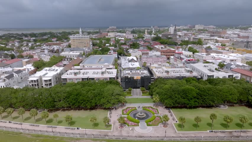 Downtown Charleston, South Carolina showing Pineapple Fountain with drone video moving left to right wide shot.