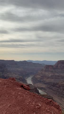 Scenic panoramic view of the Grand Canyon West Rim in Arizona, USA. Desert landscape with layered red rock cliffs, deep canyon formations, Colorado River view. A road trip near Eagle and Guano Point