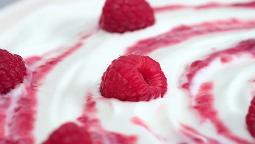 Fresh raspberry on creamy yogurt surface macro minimal composition, copy space