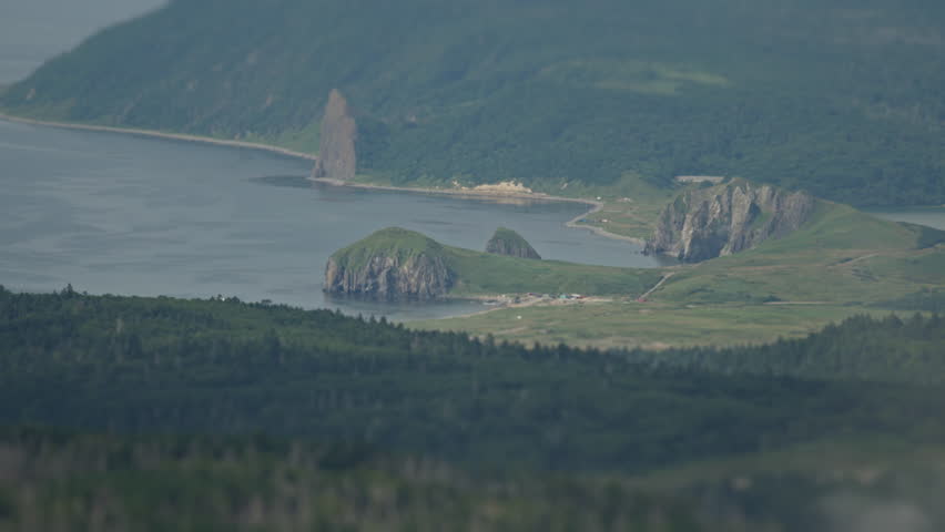 Distant view of the coast of Kunashir Island as seen from the volcano of Mendeleev. The Kuril Islands, Russia