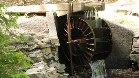 steel water wheel turning under power