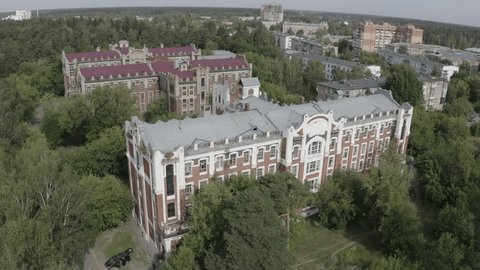 Drone Circling above Historic Buildings Trees