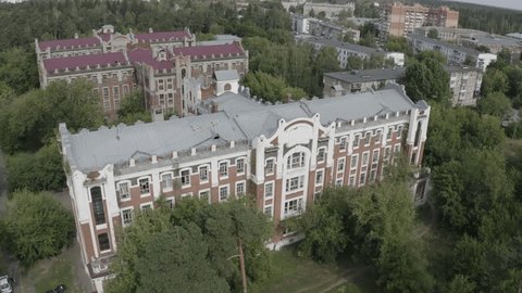 Drone Circling Historic Buildings Surrounded by Dense
