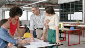 Vertical video: Designers reviewing plans for design, man marking tablet causing AR around team. Architecture, collaboration, teamwork, studio, overlays, augmented, reality - Powered by Shutterstock - Get 15% off with code: PIKWIZARD15
