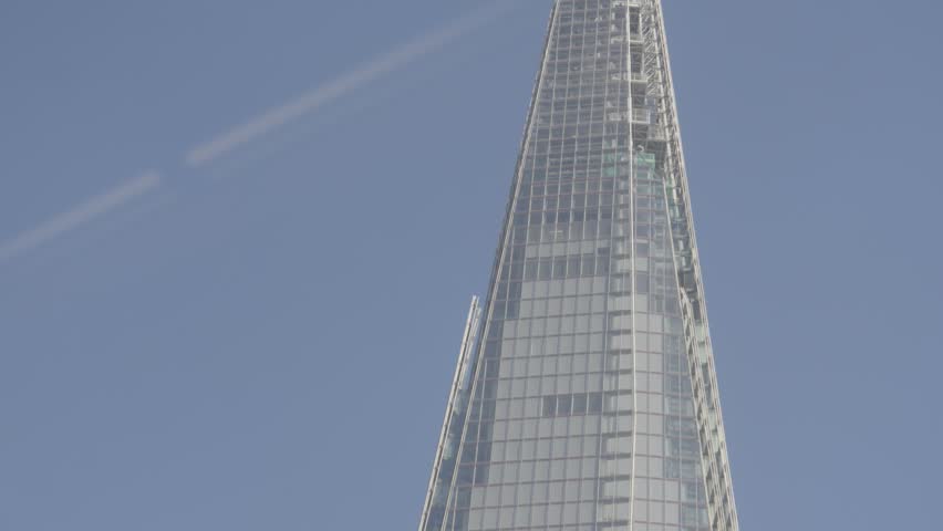 Moving Shot of Top of City of London Skyline with Shard Building Being Eclipsed by Tall Glass Office Block. Modern Architecture in Capital of England. Tallest in Western Europe.