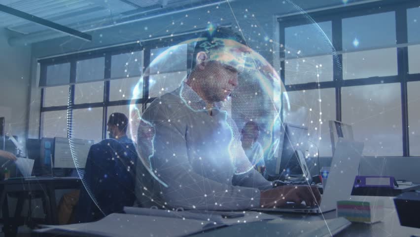 Man on phone typing for business, causing rotating holo network above as peer walking passing docs. Globe, holographic, corporate, office, laptop, monitors, collaboration