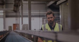 Vertical video: Warehouse tech reacting to AR HUD checking conveyor and adjusting rails to align. Inspector, technician, highvisibility, belt, augmentedreality, display, inspection - Powered by Shutterstock - Get 15% off with code: PIKWIZARD15