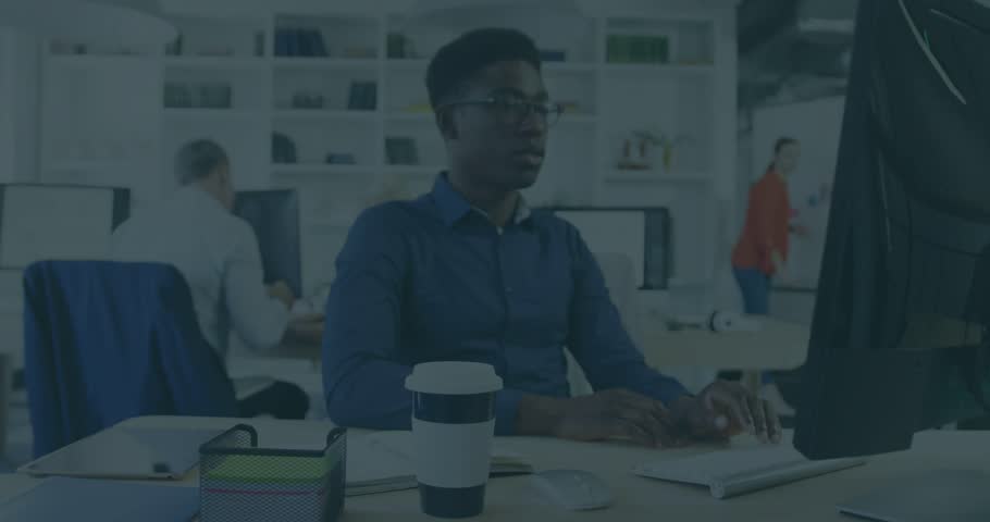 Reacting man in blue shirt shifting gaze at monitor, overlay sliding in showing File ENCRYPTION. Office, colleagues, computer, coding, data, security, desk