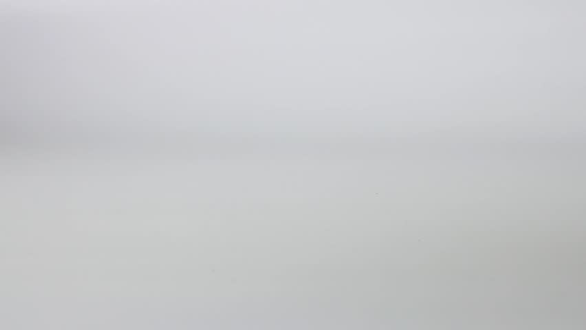 Toy race cars passing on white background, cinematic footage.