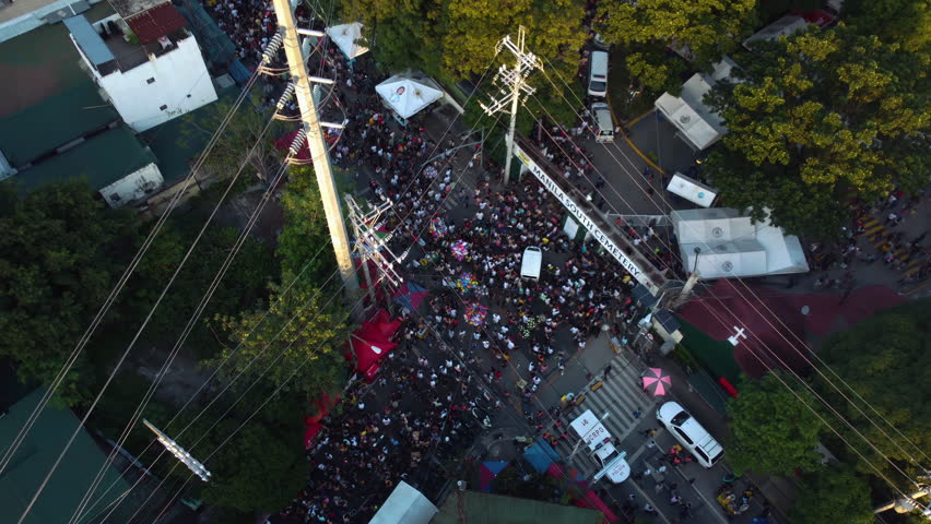 High angle aerial perspective of busy entrance gate to Manila South Cemetery in Makati