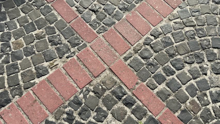 Cobblestone path with red brick accents