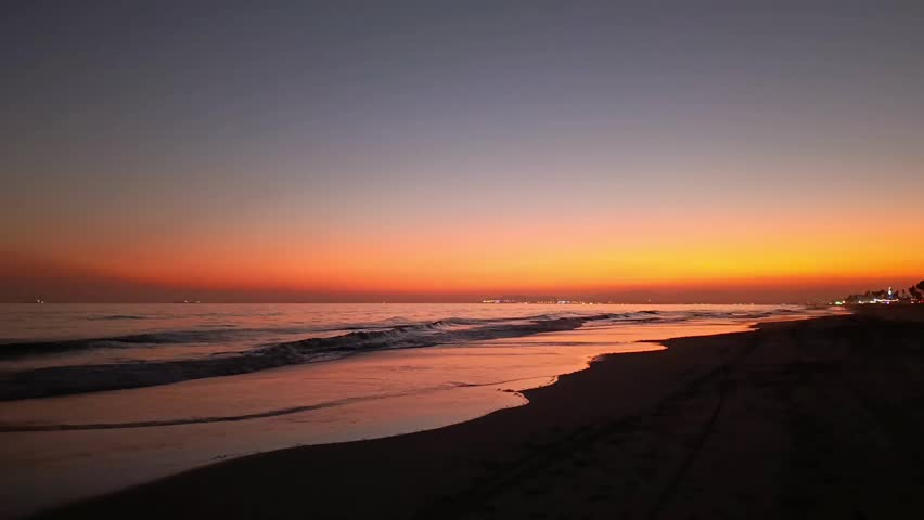 Orange sunset on Al Haffa beach in Salalah, Oman
